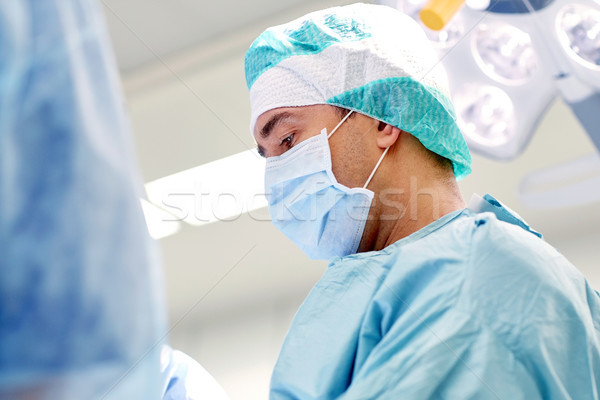 group of surgeons in operating room at hospital Stock photo © dolgachov