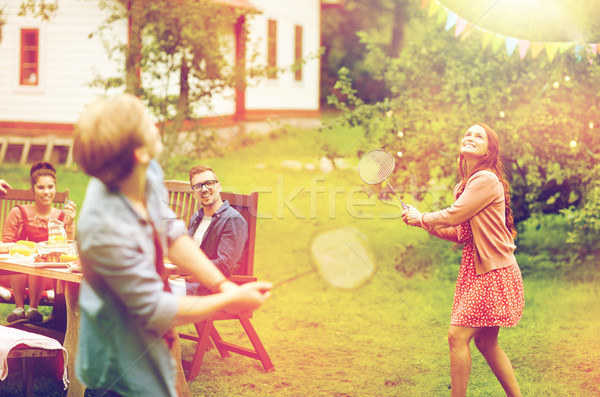 Boldog barátok játszik tollaslabda nyár kert Stock fotó © dolgachov