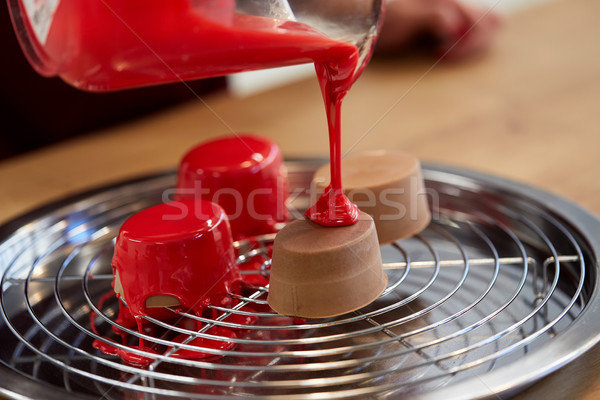 jug pouring glaze to cakes at pastry shop Stock photo © dolgachov