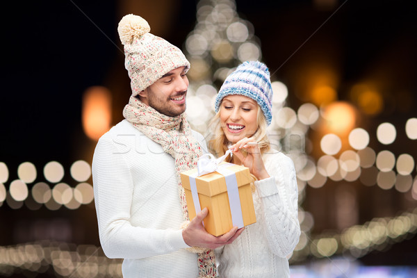 happy couple with christmas gift over night lights Stock photo © dolgachov