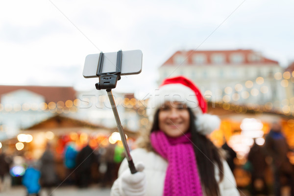 Stock photo: woman taking selfie with smartphone at christmas 