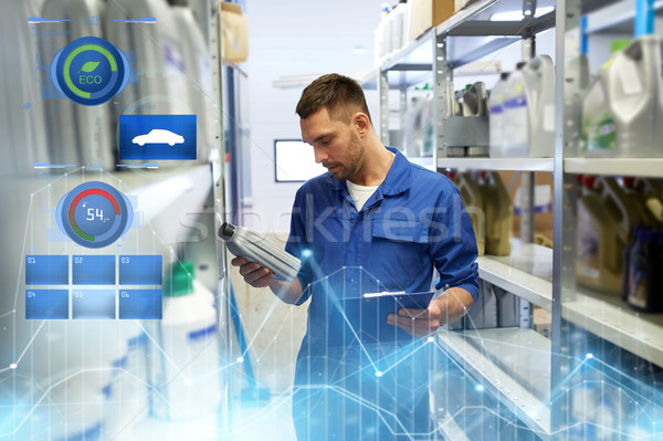 Stock photo: auto mechanic with oil and clipboard at car shop