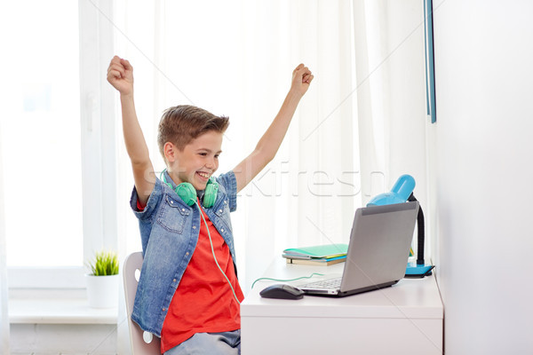 boy with headphones playing video game on laptop Stock photo © dolgachov
