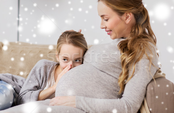 pregnant woman and girl talking to baby in belly Stock photo © dolgachov