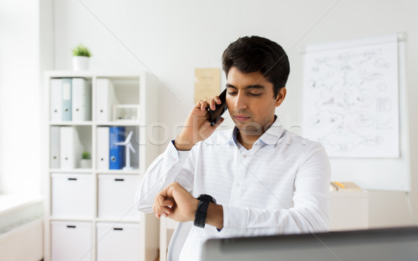 businessman calling on smartphone at office Stock photo © dolgachov