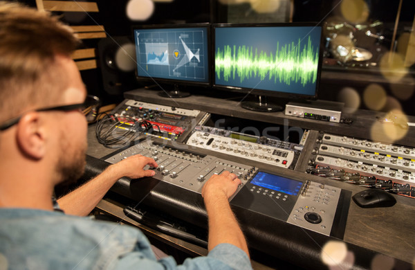 man at mixing console in music recording studio Stock photo © dolgachov