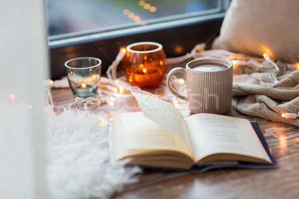 book and coffee or hot cchocolate on window sill Stock photo © dolgachov