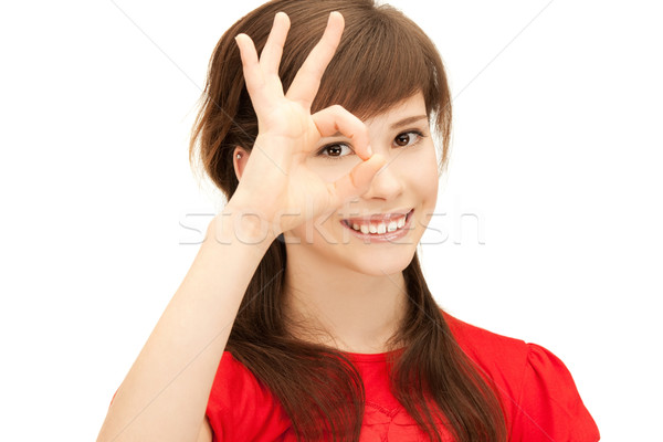 teenage girl looking through hole from fingers Stock photo © dolgachov