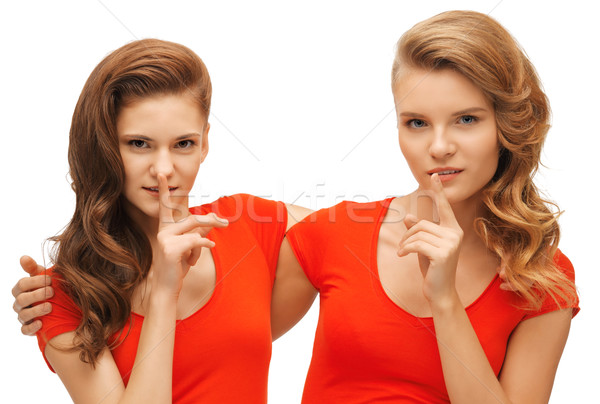 two teenage girls showing hush gesture Stock photo © dolgachov