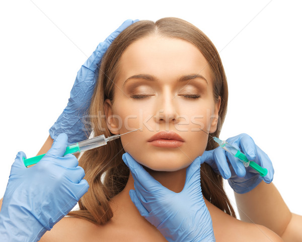 woman face and beautician hands Stock photo © dolgachov