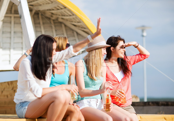 girls with drinks on the beach Stock photo © dolgachov
