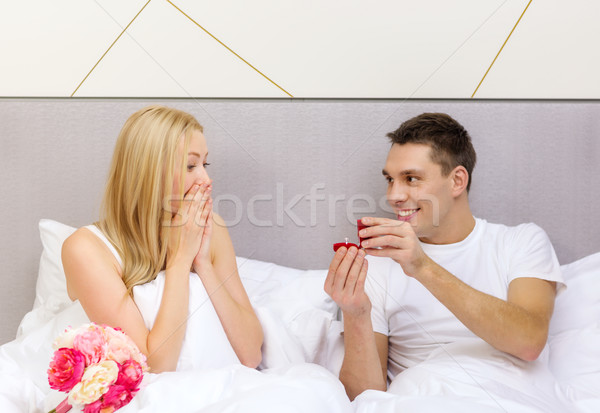 man giving woman little red box and ring in it Stock photo © dolgachov