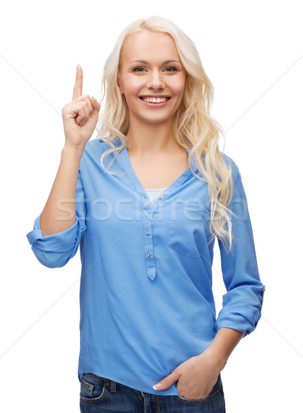 attractive young woman pointing her finger up Stock photo © dolgachov