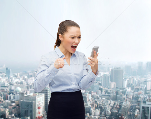 Stock photo: screaming businesswoman with smartphone