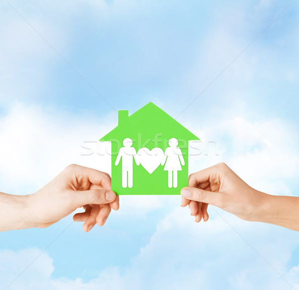 hands holding green house with family Stock photo © dolgachov