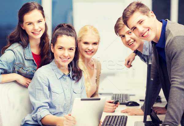 students with computer monitor and tablet pc Stock photo © dolgachov