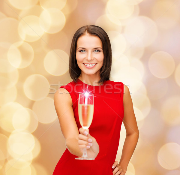 smiling woman holding glass of sparkling wine Stock photo © dolgachov