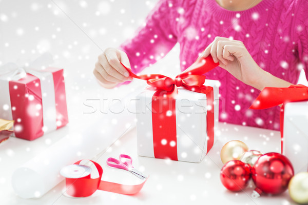 close up of woman decorating christmas presents Stock photo © dolgachov