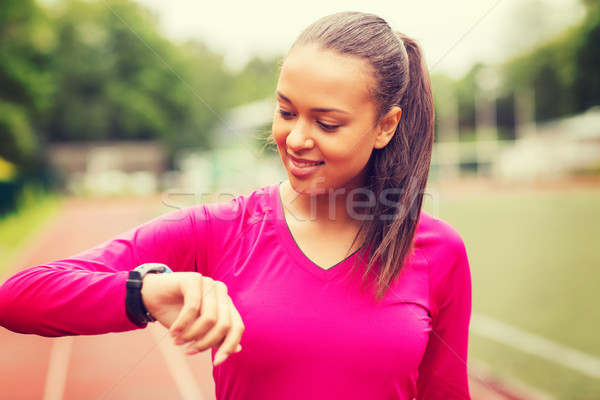 smiling woman running on track outdoors Stock photo © dolgachov