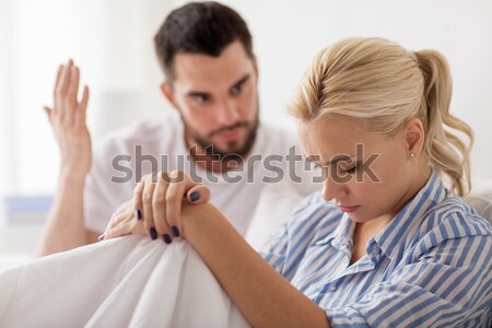 Adam oturma yatak iki kadın geri otel Stok fotoğraf © dolgachov