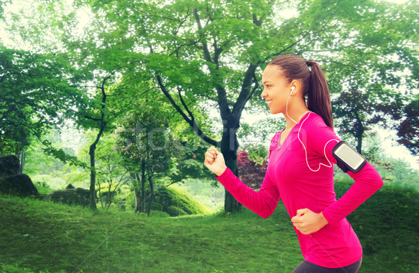 smiling young woman running outdoors Stock photo © dolgachov