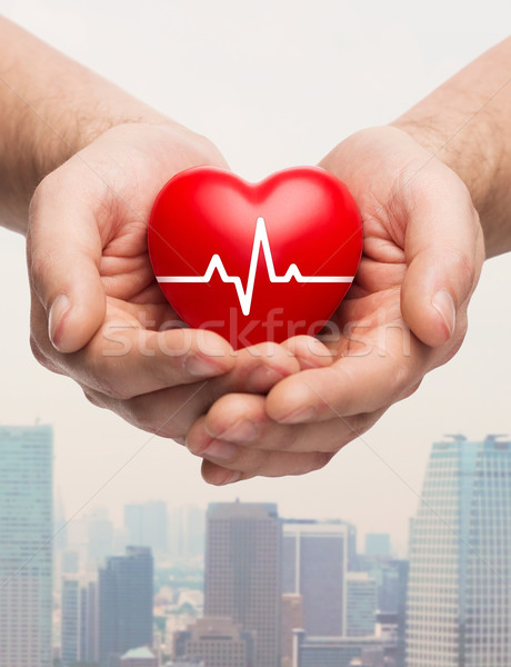 close up of hands holding heart with cardiogram Stock photo © dolgachov