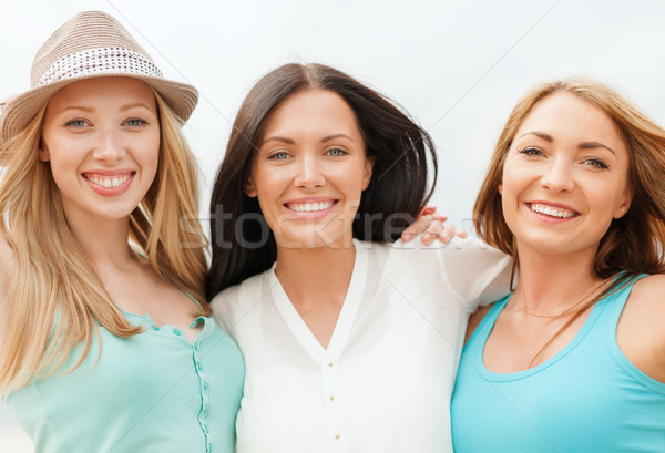 group of smiling girls chilling on the beach Stock photo © dolgachov