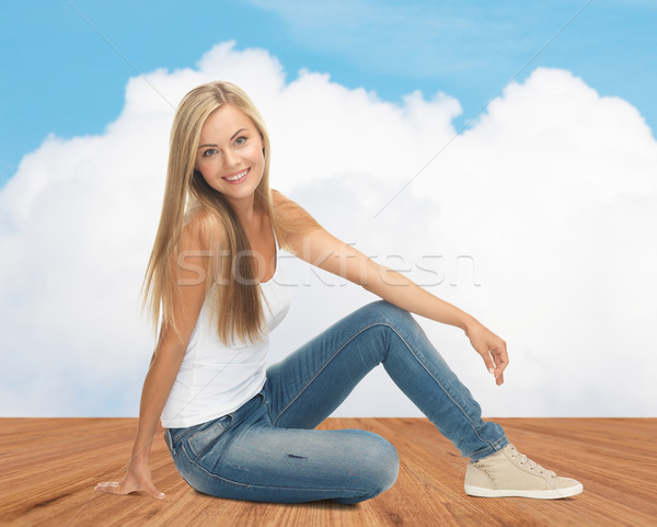 happy young woman in jeans and white tank top Stock photo © dolgachov