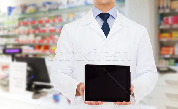 male doctor with tablet pc at drugstore Stock photo © dolgachov