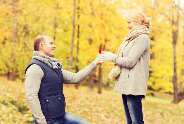 smiling couple with engagement ring in gift box Stock photo © dolgachov