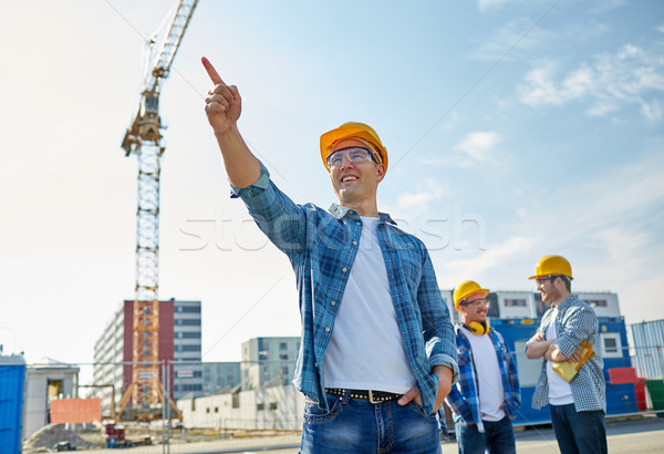 Stock photo: builders pointing finger aside on construction