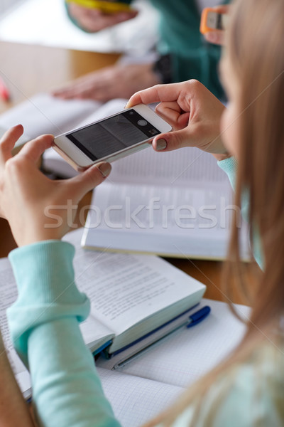 student hands with smartphone making cheat sheet Stock photo © dolgachov