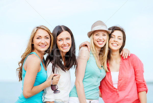 group of girls chilling on the beach Stock photo © dolgachov