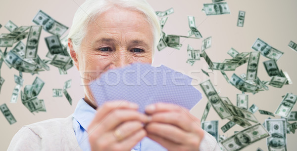 Stock photo: close up of happy senior woman playing cards