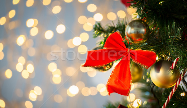 close up of red bow decoration on christmas tree Stock photo © dolgachov