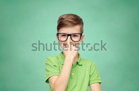 confused teenage student girl covering her mouth Stock photo © dolgachov