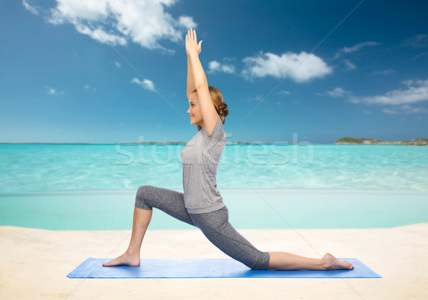 happy woman making yoga in low lunge on mat Stock photo © dolgachov