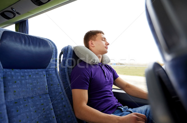 happy young man sleeping in travel bus with pillow Stock photo © dolgachov
