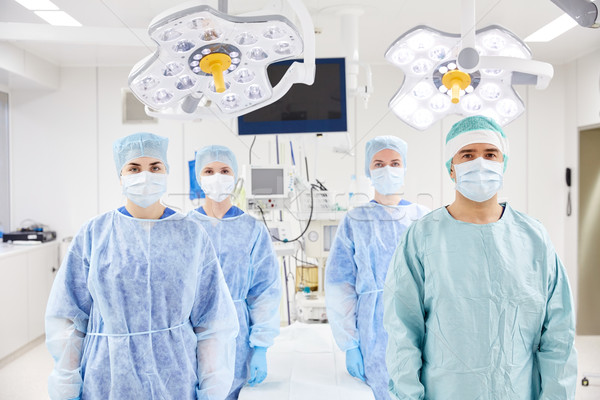 group of surgeons in operating room at hospital Stock photo © dolgachov