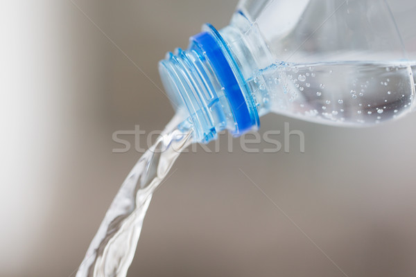close up of water pouring from plastic bottle Stock photo © dolgachov