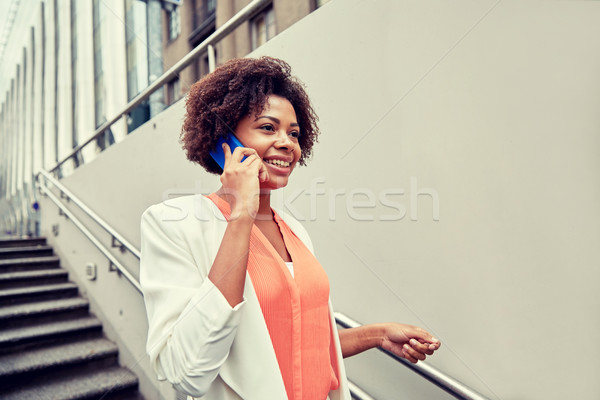 happy african businesswoman calling on smartphone Stock photo © dolgachov