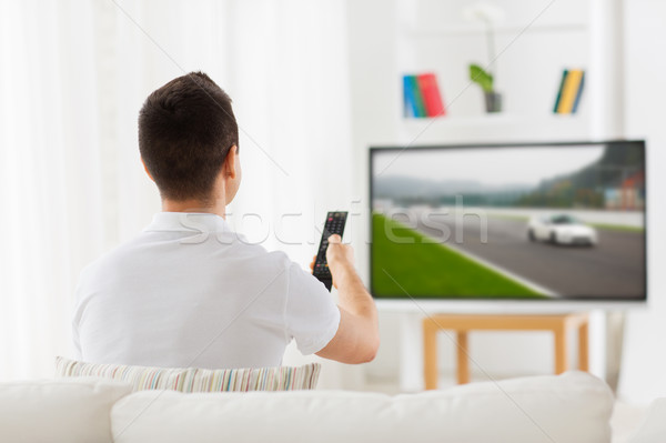 Adam uzak izlerken tv ev boş Stok fotoğraf © dolgachov