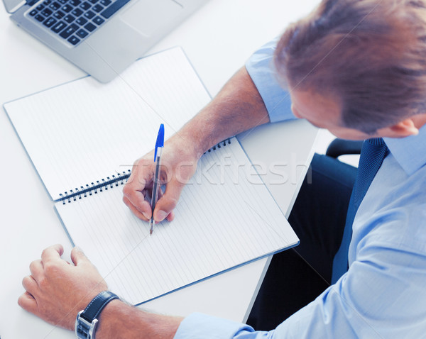 businessman writing in notebook Stock photo © dolgachov