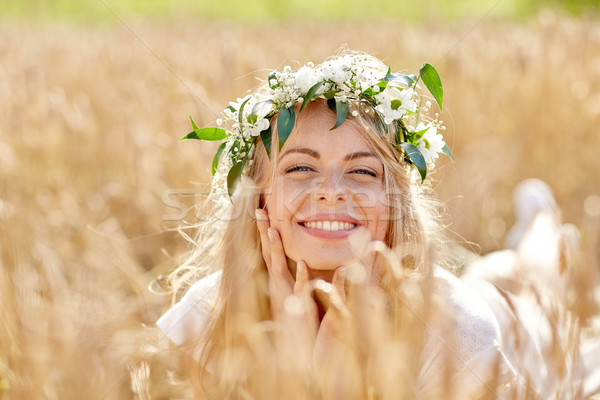 happy woman in wreath of flowers on cereal field Stock photo © dolgachov