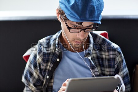 close up of man with tablet pc and earphones Stock photo © dolgachov