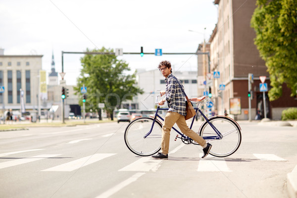 young man with fixed gear bicycle on crosswalk Stock photo © dolgachov