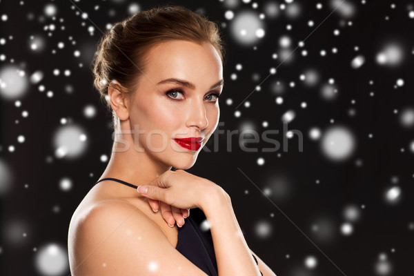 beautiful woman over black background and snow Stock photo © dolgachov