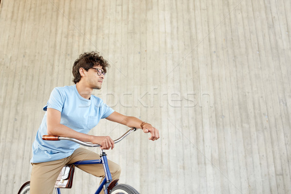 Stock photo: young hipster man riding fixed gear bike