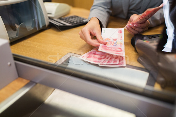 clerk counting cash money at bank office Stock photo © dolgachov