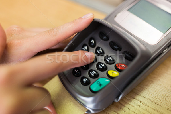 close up of hand entering code to money terminal Stock photo © dolgachov